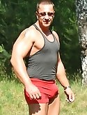 Musclehunk Aaron Giant jerking off in a public park